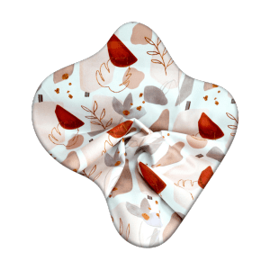 Light pastel fabric with playful abstract patterns in red, beige, and grey tones.