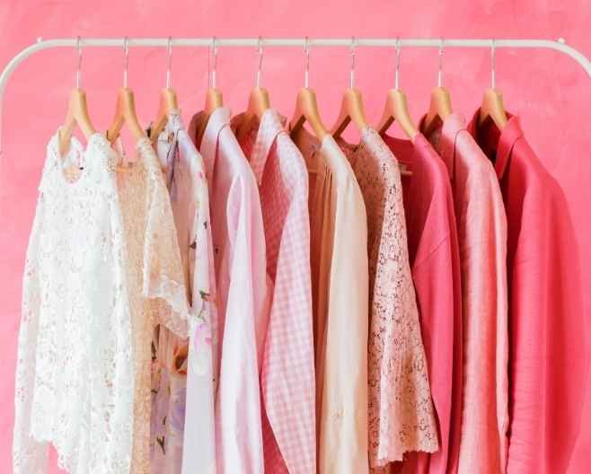 Clothing rack with pastel and pink outfits