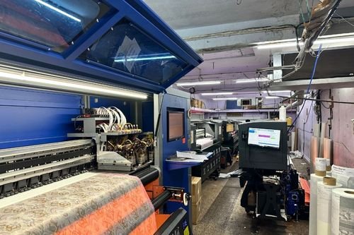 Digital textile printing machines printing fabric inside a production unit