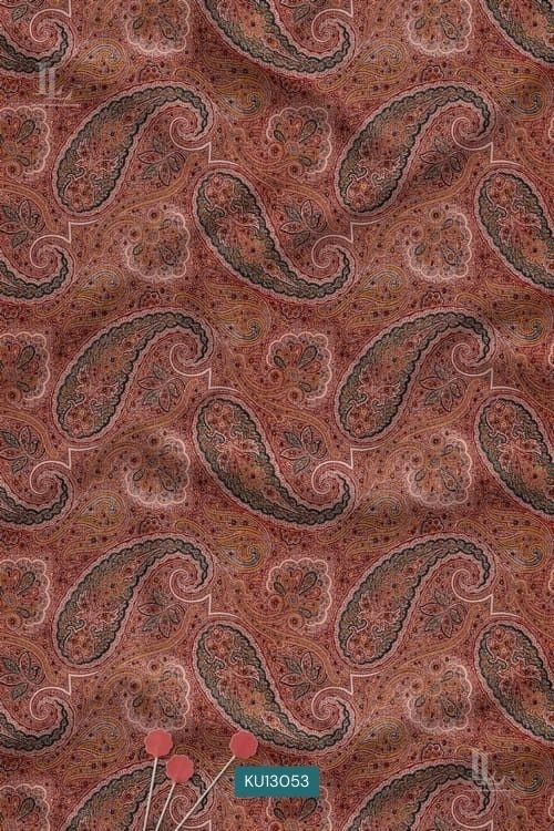 Rust colored fabric with detailed traditional paisley digital print