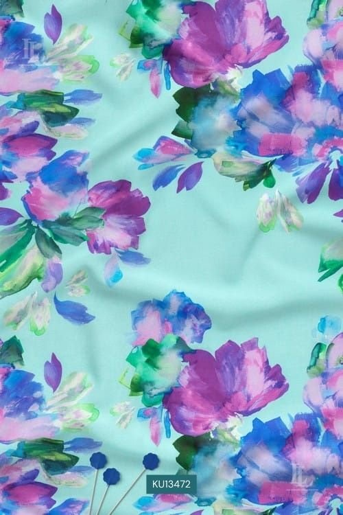 Vibrant blue and purple watercolor floral print on mint green fabric