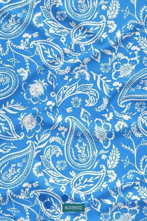 Intricate white paisley and floral print on a vibrant azure blue fabric