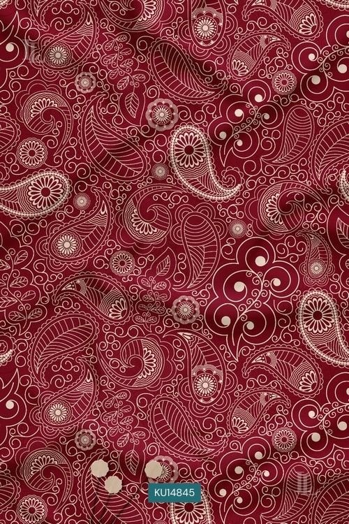 Maroon fabric with intricate cream paisley and vine print pattern