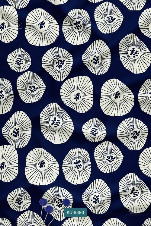 Ivory radial sunburst floral motifs on a deep midnight indigo blue fabric